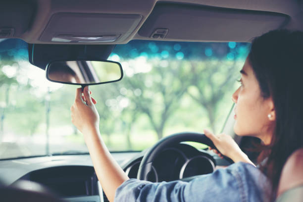 Side and rearview mirrors showing traffic behind and beside the vehicle, highlighting the importance of mirrors in driving.